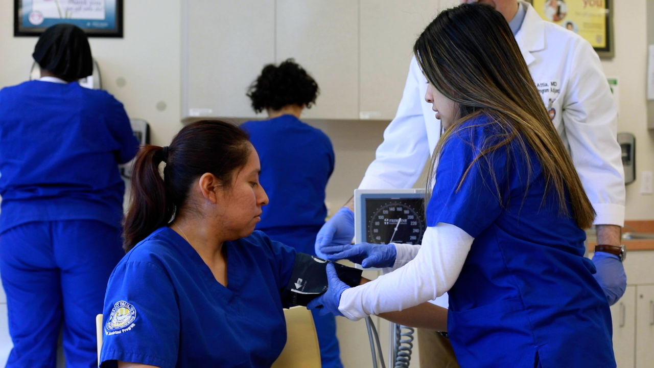 Nursing students practice blood pressure measurement in clinic