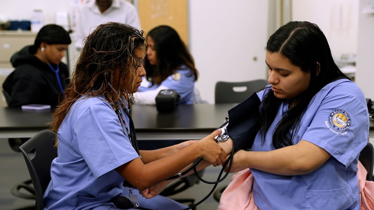 Nursing students practice blood pressure measurement in classroom